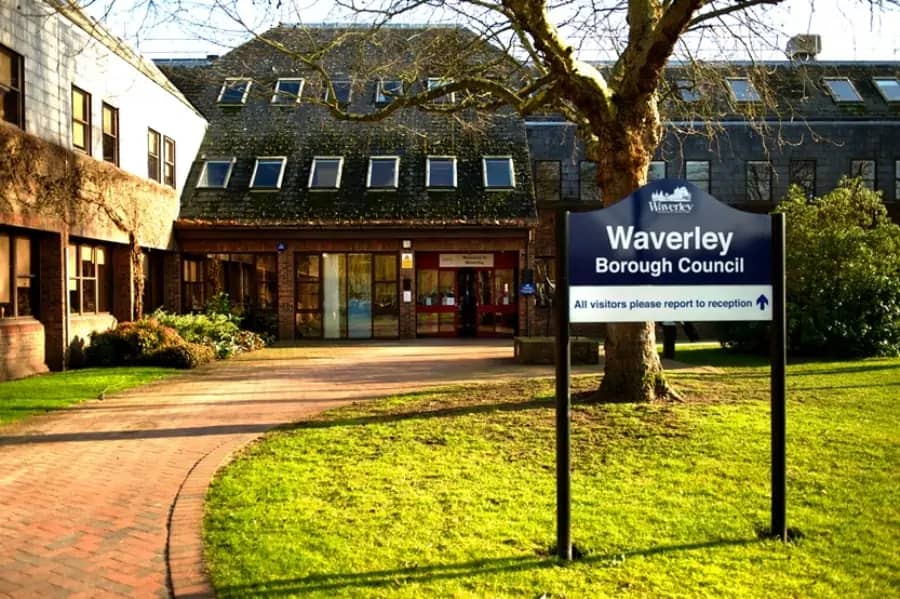 Waverley Borough Council building with a sign directing visitors to reception. As a Local Planning Authority (LPA), councils like Waverley are responsible for enforcing Biodiversity Net Gain (BNG) regulations, assessing biodiversity gain plans, monitoring compliance, and issuing penalties for non-compliance.